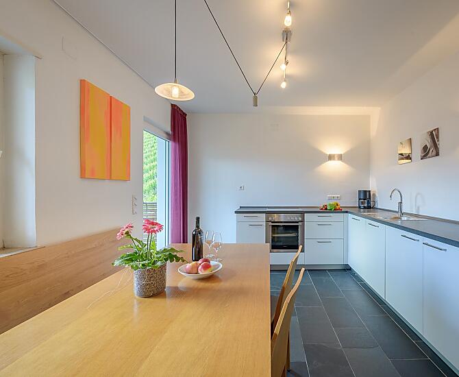 Die südseitig ausgerichtete Küche mit Balkon, großem Esstisch und angrenzendem Wohnzimmer mit Doppelschlafcouch und SAT/TV für 5-7 Personen.
